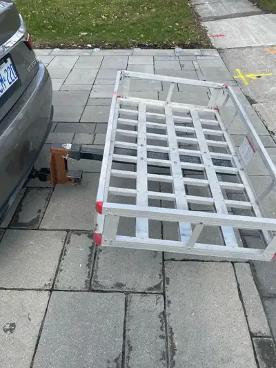 I'm selling a used trailer cargo carrier designed to attach to a vehicle's hitch for extra storage s...