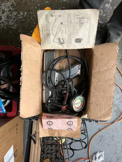 Classic car engine tuning and analysis tools. A timing light, an engine analyzer and a vacuum gauge....