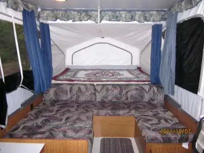 Used 2 times per year, stored inside garage. Has a queen bed and a double bed, plus a table that con...