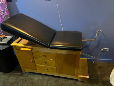 Exam table complete with stainless steel stirrups. Very solid and unique design, a bold piece for yo...