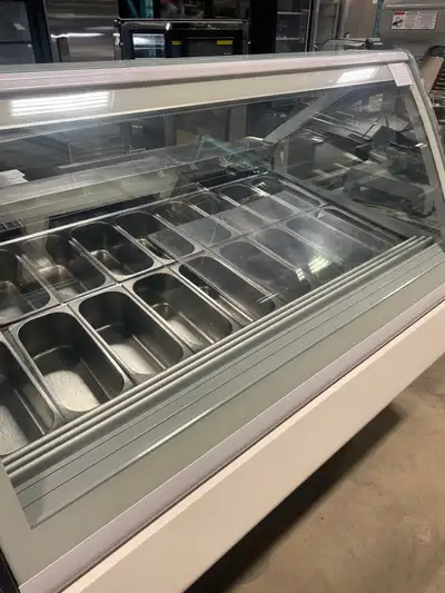 You are viewing a nicely used 66" wide commercial 18 pan gelato display case freezer. This Orion Tec...