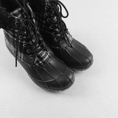 Step out in style with these cozy plaid duck boots, perfect for braving the elements while keeping y...