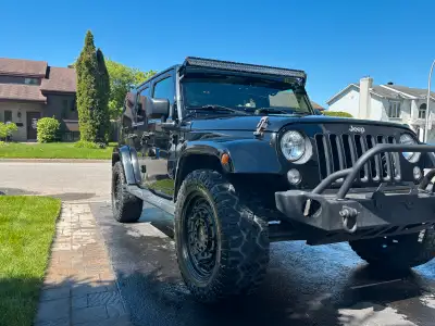 This Jeep Wrangler Sahara Limited is ready for adventure, boasting a powerful engine and rugged desi...