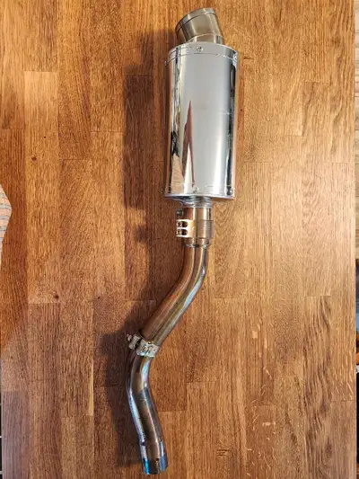 This is an aftermarket Delkevic slip on exhaust. Simple bolt on with no modifications. It is a 15 mi...