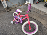 Pink bike with training wheels 