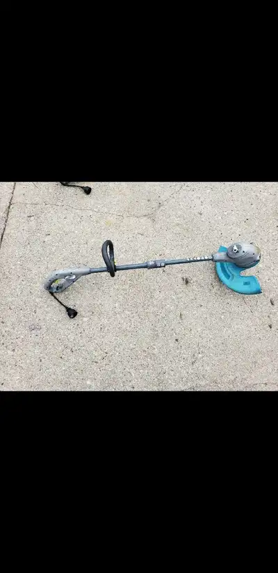 This is a string trimmer, perfect for keeping your lawn edges neat and tidy. This tool is used and s...