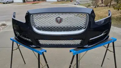 Shell, and parking sensors is OEM, sides and top center grill's is aftermarket. Center bottom grill...