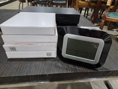I'm selling a new La Crosse Technology digital clock, model WT-8005U-B-INT, still in its original pa...