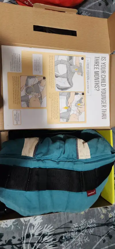 Manduca baby carrier in original box and instruction manual included.