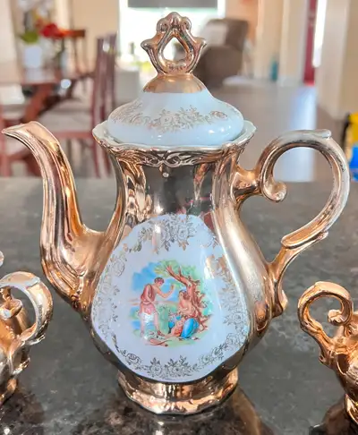 Elegant Tea Pot Set includes a teapot, sugar bowl, creamer, and 12 cups with saucers. The pieces are...