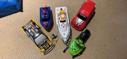 5 TOY VEHICLES BOAT SNOWMOBILE RACE CARS NEW BATTERIES NEEDED in Toys & Games in Peterborough