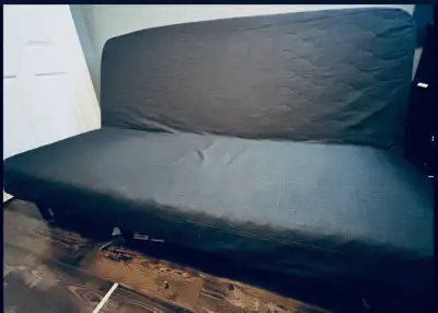 Navy blue futon. Perfect for a guest room, basement or play room. Can make a bed or a couch quickly....