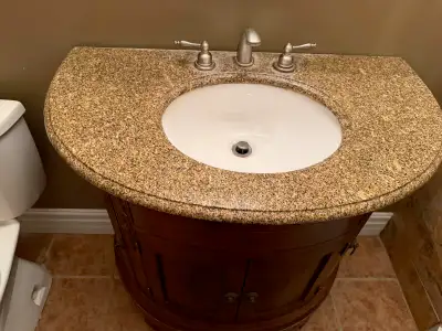 Beautiful solid wood bathroom vanity in excellent condition. Features a unique curved front design w...