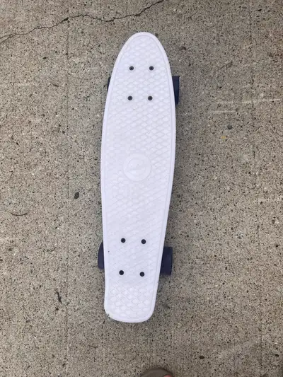 This white Penny plastic cruiser skateboard is a compact and nimble ride, perfect for getting around...