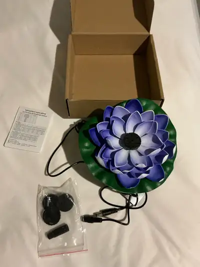 Brighten up your space with this like new solar lotus fountain! This beautiful fountain features a s...
