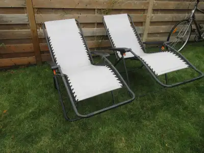 Used Zero Gravity Patio Chairs in light grey color $30 each or both for $50 Je parle Francais aussi