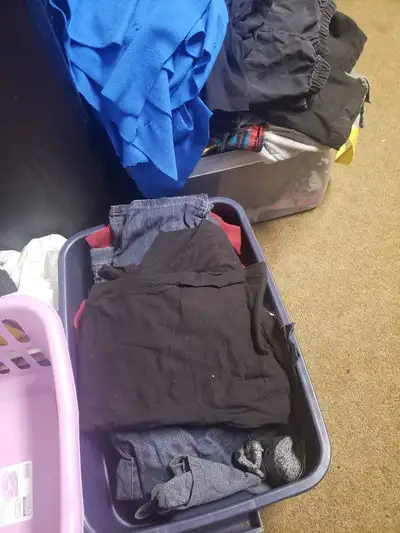 2 bins of free clothing. lots of size medium & large t shirts, some jeans, 4 jackets, 1 pair of worn...