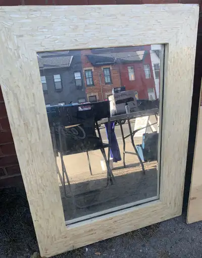 Elevate your home decor with this stylish mirror, featuring a unique mosaic tile frame. This mirror...