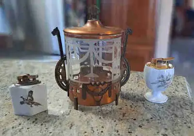 Selling my beautiful 2 table lighters. One has a Pheasant painted on it and the other is a Ronson an...
