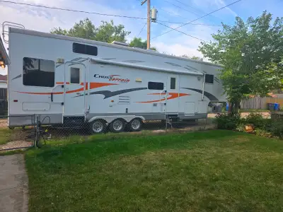 2006 toy hauler queen room with sink and stand up shower amd bathroom Leather futon in living room,...