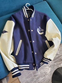 Vancouver Canucks bomber jacket, leather sleeves.