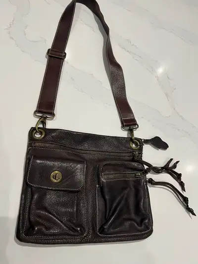 Roots dark brown leather Village bag. Dimensions 9” length x 11” width.