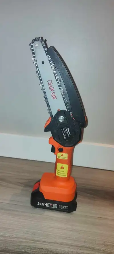 Mini Chainsaw with battery. Works well, View more