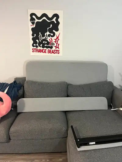 Slattum Ikea Bedframe in grey with soft upholstery and a padded headboard, with plenty of space unde...