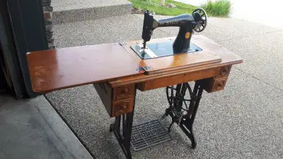 Singer Treadle Sewing Machine in the original Wooden Cabinet., View more