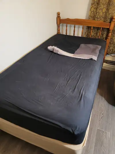 Twin bed frame with headboard, matres and box spring. A complimentary set of sheets.