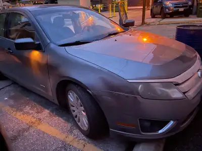 Grey Ford Fusion Hybrid 2010 in good working condition with no repairs necessary except some rust. G...
