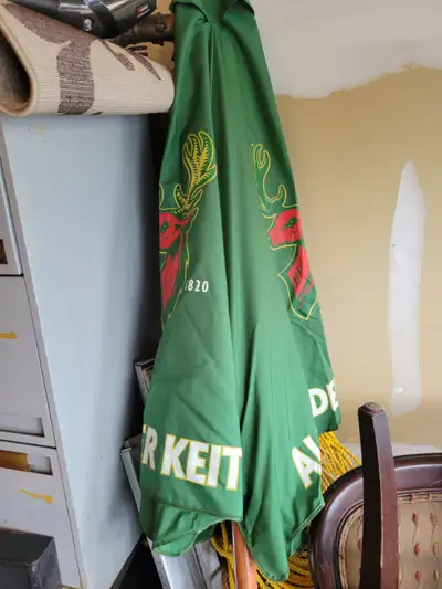 restaurant patio umberlla with black iron base to sell. 4 different colors available. Price $125 eac...