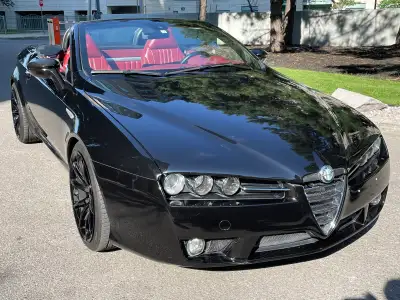 For sale is a used Alfa Romeo Spider, a classic convertible sports car that offers a thrilling drivi...