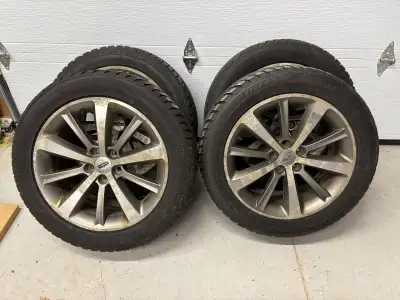 Four 19" aluminum wheels with Uniroyal Tiger Paw snow tires. Size: 235/55R19. Wheel bolt pattern is...