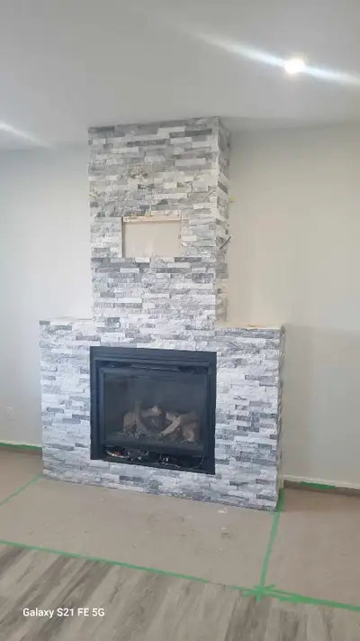 I lay tiles and stone. Floor, bathroom walls and floor, kitchen area backsplash, fireplaces, stone f...