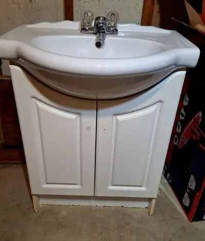 White Bathroom vanity with sink. Height is 3ft 11inches. Width is 2ft 3 inches