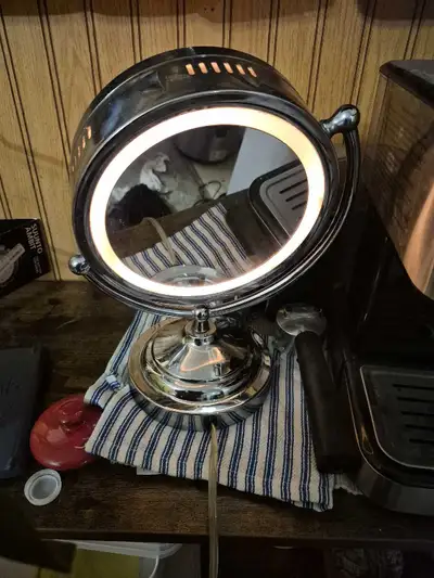 Magnifying Light up Makeup Mirror Electric siver Tone ( Homedics ). Height 14 inches. Diameter of mi...