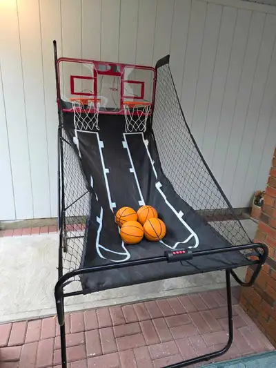 This is an electronic scoreboard operated basketball game. Comes with four basketballs folds up very...