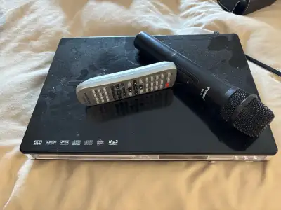 Karaoke machine with remote and wireless microphone