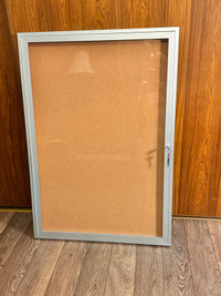 Enclosed cork board with aluminum frame. 2 ft by 3ft.