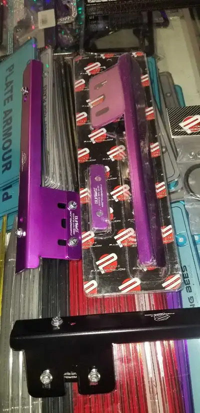 This is a new, purple universal license plate relocation bracket, adding both style and functionalit...