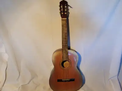 classical guitar **missing 4 frets and has a small hole, View more