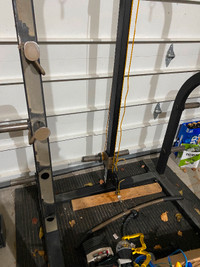 Squat rack with lat pull-down and weight stand built in.