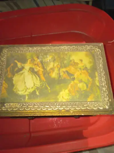This is a vintage, 2-drawer music box with a gold finish and a classical scene on the lid. The inter...