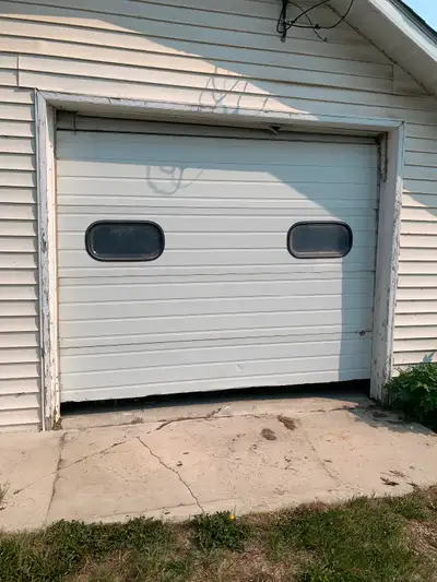 8ft 8 inch high x 10 ft wide used overhead door for parts or repair. Needs new cables and bottom of...