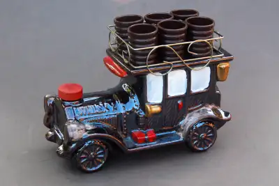 Available is a ceramic spirits decanter in the form of a 1910 vintage truck. The roof rack sits 6 pl...