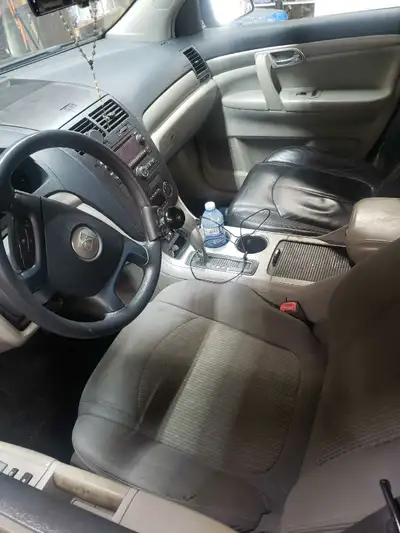 This is a used Saturn Outlook 2009, perfect for families or anyone needing extra space, featuring a...