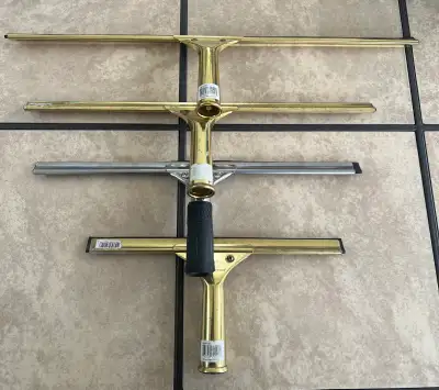 These four professional-grade window squeegees come in various sizes and are in used condition, show...