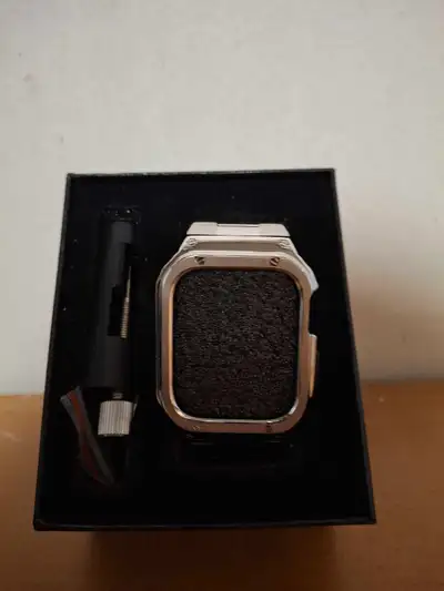 Elevate your Apple Watch with this stylish silver metal case and applicator tool. This used case wil...