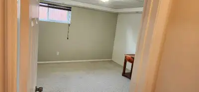 This cozy, pre-loved basement room offers a quiet and comfortable living space, featuring clean neut...